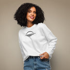 Woman wearing an organic cotton white sweatshirt with a sunset emblem on a beige background