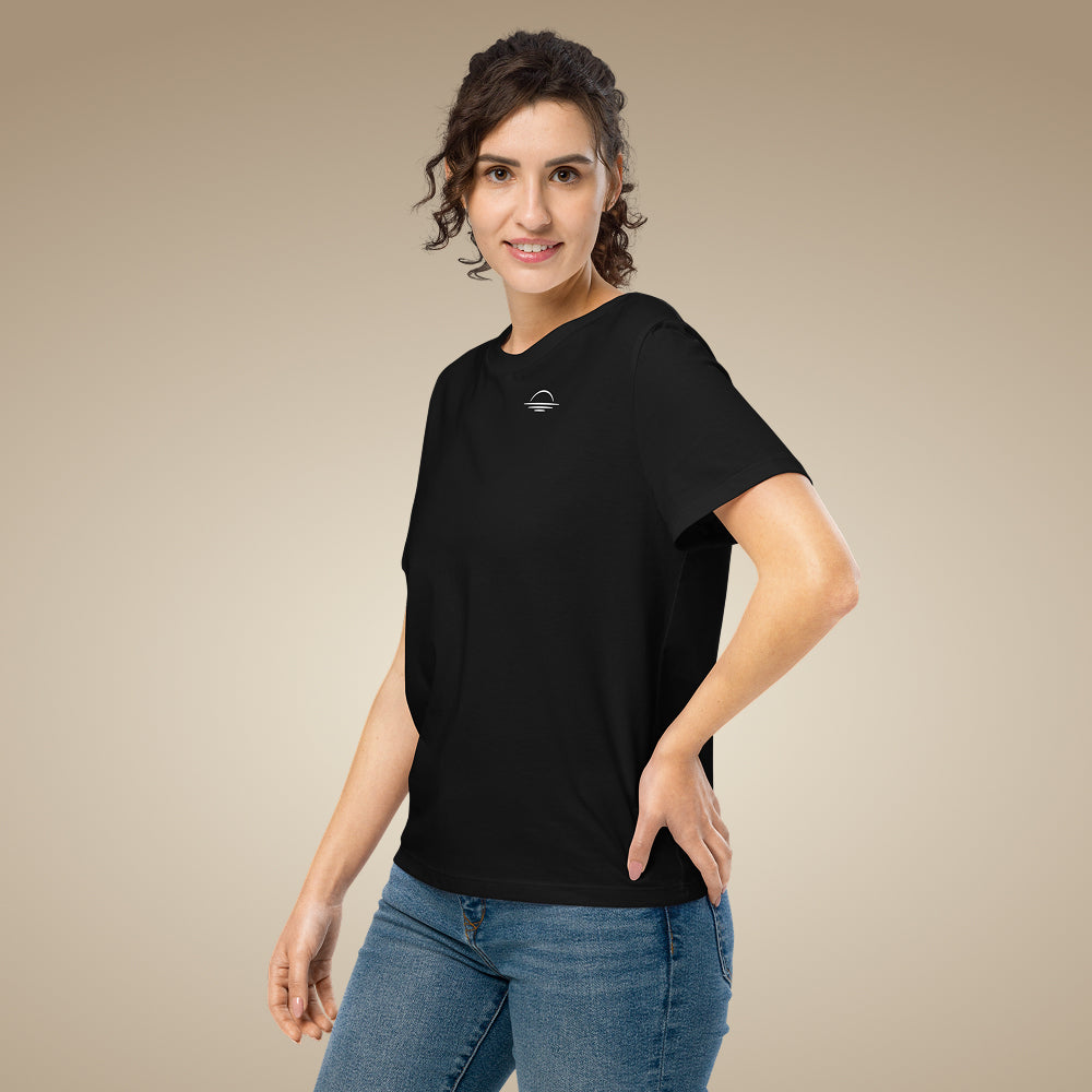Woman wearing a black organic cotton t-shirt with a sunset icon on a beige background