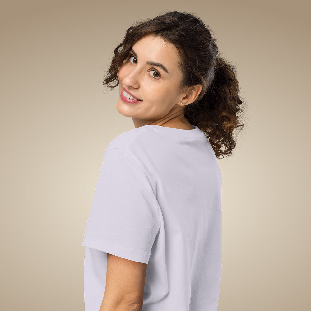 Woman wearing a light lavender organic cotton t-shirt against a beige background