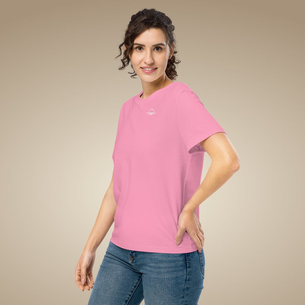 Women’s organic cotton t-shirt in bubble pink with minimal chest logo, worn by model
