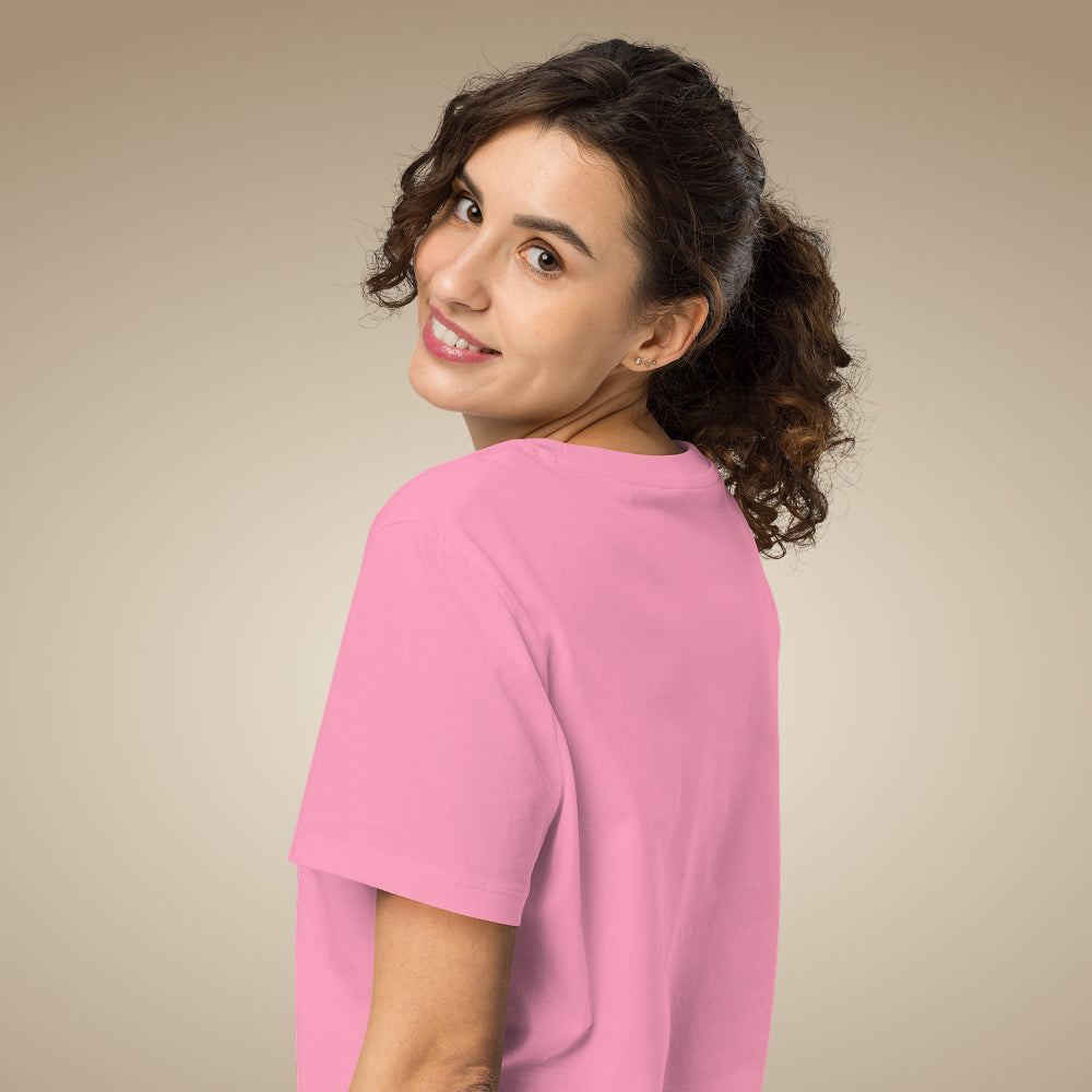 Women’s organic cotton t-shirt in bubble pink with minimal chest logo, worn by model