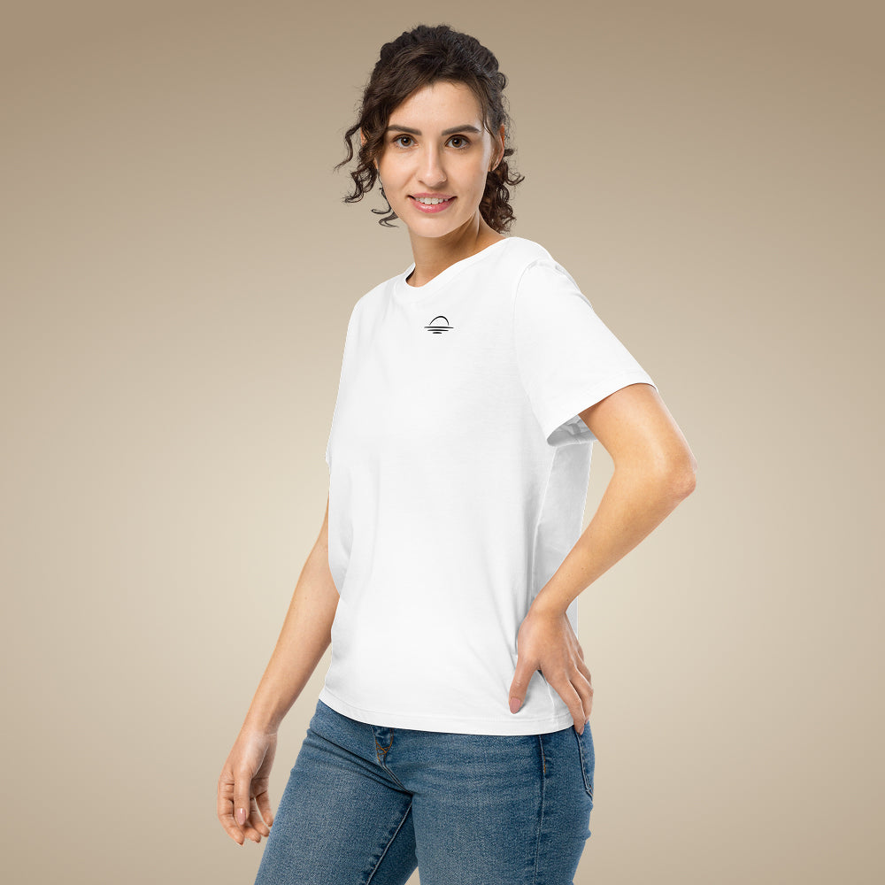 Women’s organic cotton t-shirt in white with minimal chest logo, worn by model
