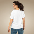 Woman wearing a white t-shirt and blue jeans on a beige background
